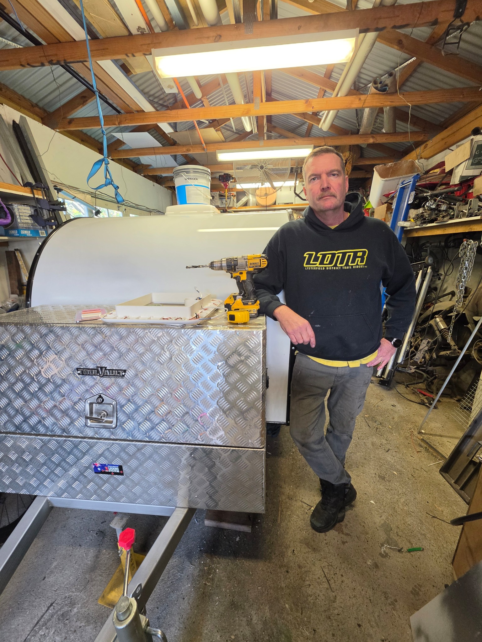 Derek beside a green Mini Camper in his workshop Derek standing beside a green Mini Camper in his Bentleigh workshop